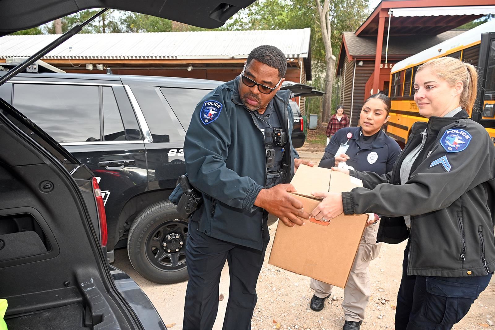 CFISD police officers met at Cy-Hope on Nov. 21 to load their service vehicles and a CFISD school bus with the 50 meals.